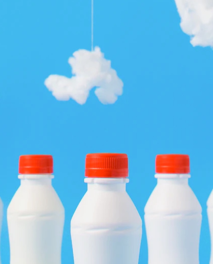 3 milk bottles on a cloudy background