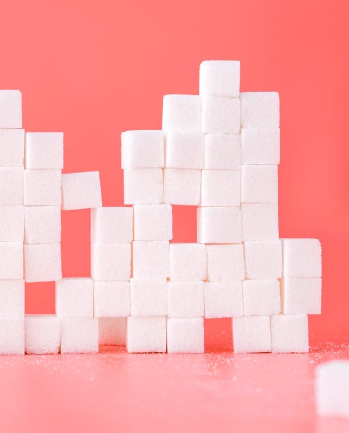 sugarcubes stacked on a pink background